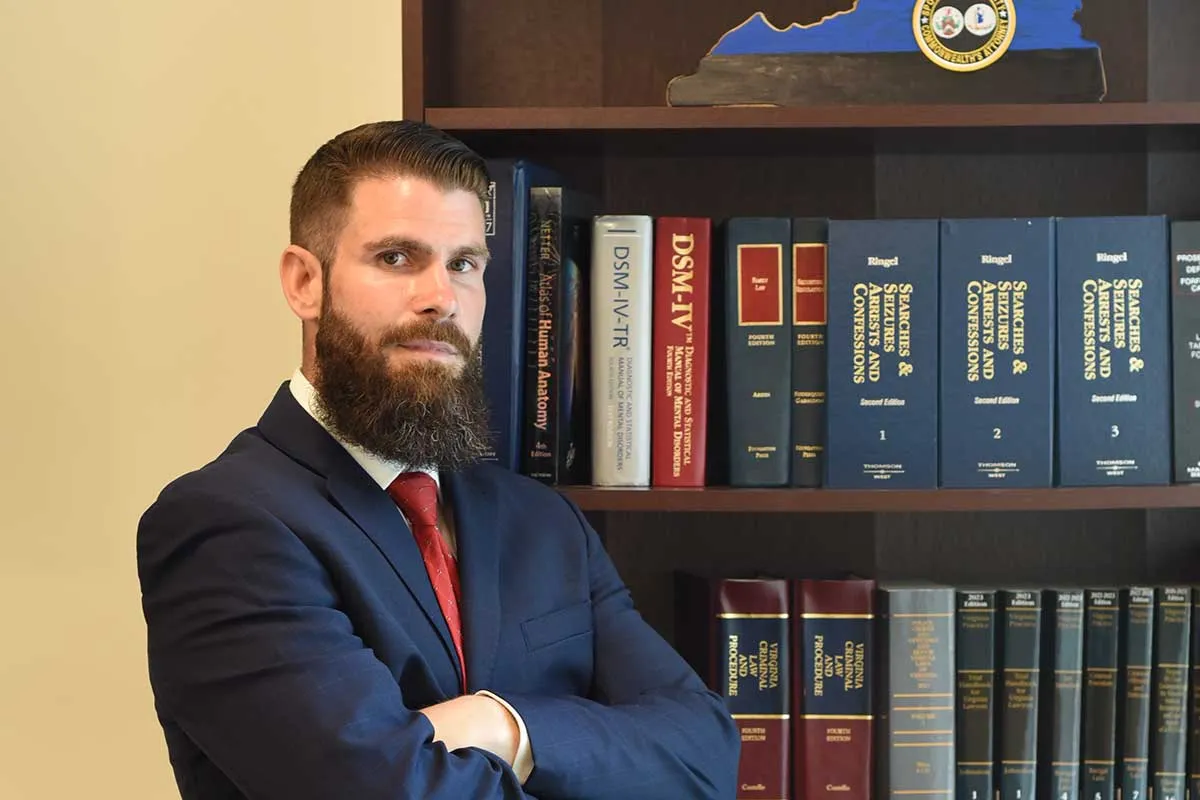 Ryan Mehaffey seated in his office in front of a law library